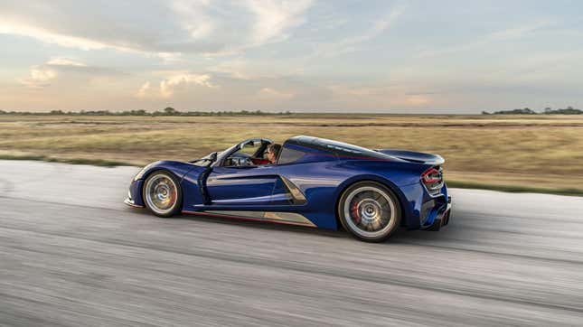 A blue Hennessey Venom F5 Roadster driving on track