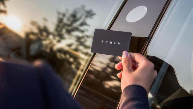 A Tesla Model 3's key card held next to the B Pillar