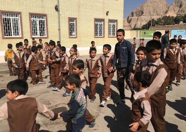 Iranian and Afghan boys play outside at the Be’sat school in Kerman, Iran.