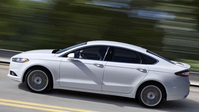 A photo of a white Ford Fusion sedan. 