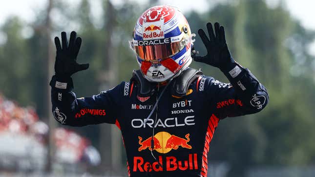 A photo of Max Verstappen with his hands up. 