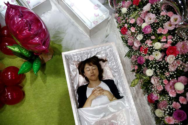 Staff member lies in a casket demonstrating Okuribito funeral’s funeral service at the Life Ending Industry Expo in Tokyo. (Reuters/Kim Kyung-Hoon )