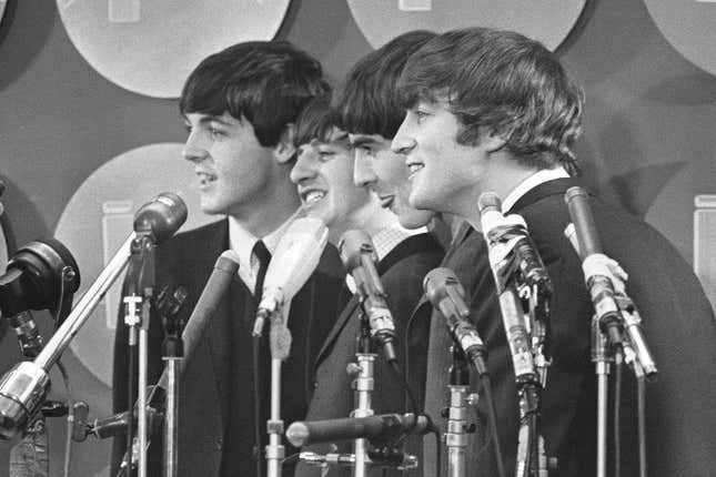 FILE - The Beatles address the media in the press room of Kennedy International Airport on their arrival, Feb. 7, 1964 in New York. The Beatles are getting the big-screen biopic treatment in not just one but a Fab Four of movies that will give each band member their own film, all of which are to be directed by Sam Mendes. (AP Photo, File)