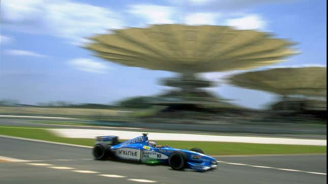 A Benetton Playlife F1 car drives round the Malaysian Grand Prix circuit. 