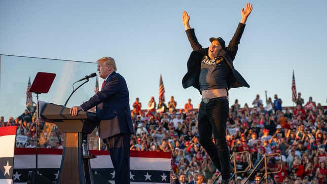 Tesla CEO Elon Musk (R) jumps on stage as he joins former US President and Republican presidential candidate Donald Trump during a campaign rally at site of his first assassination attempt in Butler, Pennsylvania on October 5, 2024. 