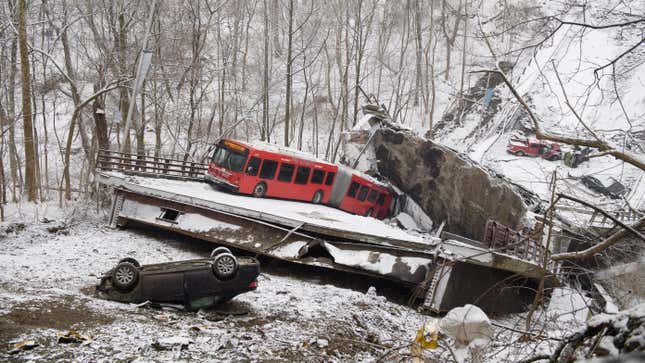 The collapsed road deck of the Fern Hollow Bridge sitting in a ravine