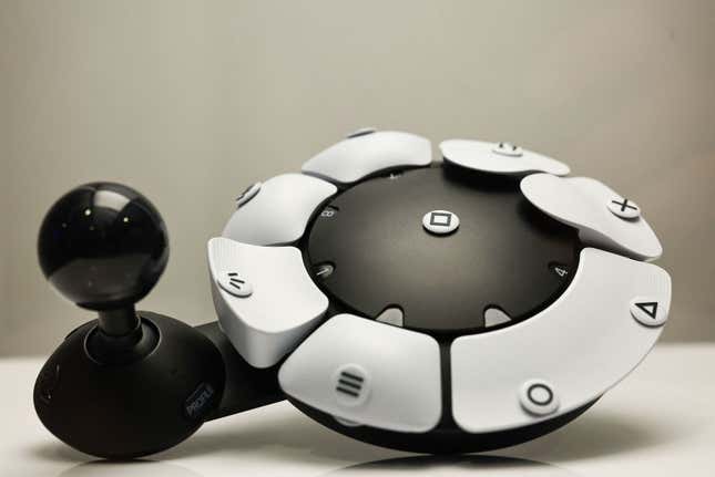 The PlayStation Access controller has a joystick on one side and a configurable array of buttons arranged in a circle. 