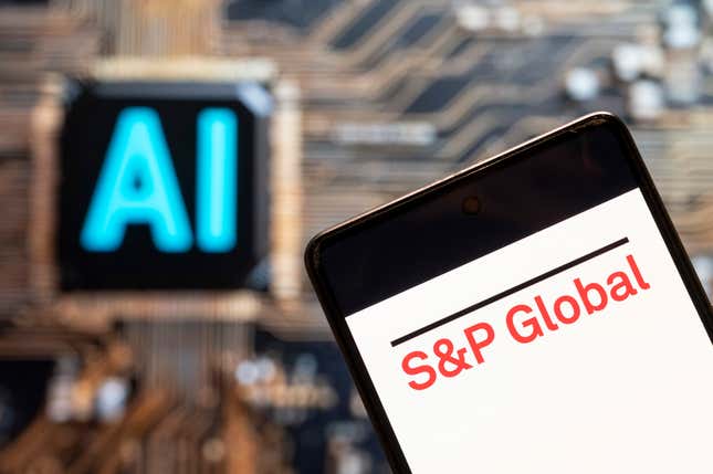 S&P Global logo seen displayed on a smartphone with an Artificial intelligence (AI) chip and symbol in the background.