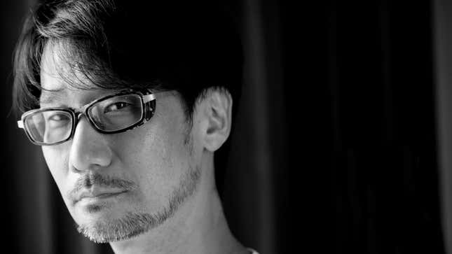 Hideo Kojima looks at the camera in a black and white shot.