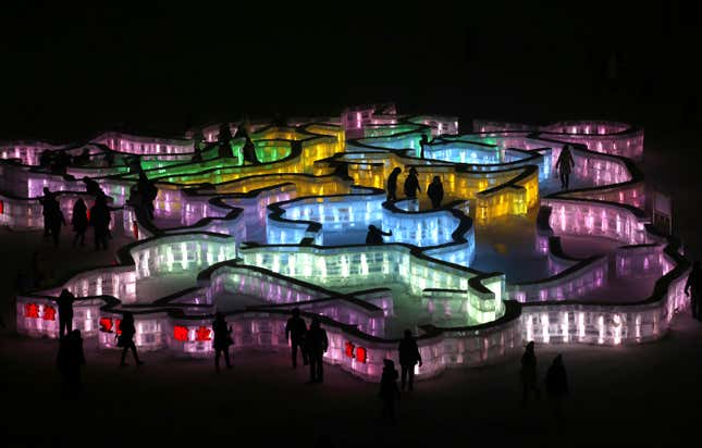 People visit a maze which was built by ice bricks and illuminated by coloured lights during a trial operation ahead of the 31st Harbin International Ice and Snow Festival in the northern city of Harbin, Heilongjiang province, January 4, 2015. The winter festival will be officially opened on January 5, 2015. REUTERS/Kim Kyung-Hoon