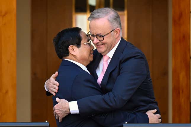 Australian Prime Minister Anthony Albanese, right, and Vietnamese Prime Minister Pham Minh Chinh embrace at the end of a joint statement at Parliament House in Canberra, Thursday, March 7, 2024. The Australian and Vietnamese prime ministers have discussed ways of improving an already booming economic relationship. (Lukas Coch/AAP Image via AP)