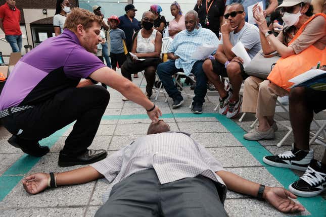 A trainer shows how to use Narcan at a community event