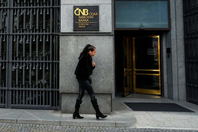 FILE - A woman walks outside the czech central bank in Prague, Czech Republic, on Nov. 2, 2023. On Thursday Feb. 8, 2024, the Czech Republic&#39;s central bank cut its key interest rate for the second straight time in efforts to help the country&#39;s struggling economy. The cut by a half percentage point brought the interest rate down to 6.25%. (AP Photo/Petr David Josek/File)