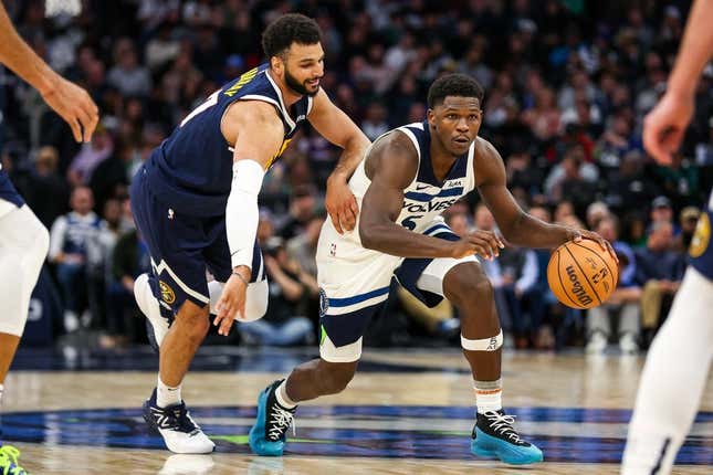 Nov 1, 2023; Minneapolis, Minnesota, USA; Minnesota Timberwolves guard Anthony Edwards (5) drives while Denver Nuggets guard Jamal Murray (27) defends during the second half at Target Center.