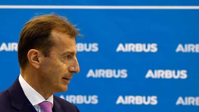 Airbus CEO Guillaume Faury in front of a blue-and-white Airbus step-and-repeat