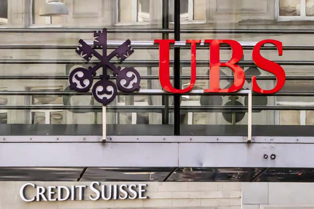 FILE - Logos of the Swiss banks Credit Suisse and UBS are seen on two buildings in Zurich, Switzerland, Saturday, March 18, 2023. The Swiss government has announced steps to bolster its “too big to fail” rules aimed to avoid potentially disastrous fallout from banking sector turmoil. The comes in the wake of woes at troubled bank Credit Suisse before it was taken over by rival UBS. (Michael Buholzer/Keystone via AP, File)