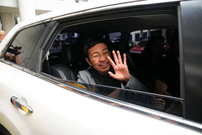 Filipino journalist Maria Ressa, 2021 Nobel Peace Prize winner and Rappler CEO, waves from her car after being acquitted by the Pasig Regional Trial Court over a tax evasion case in Pasig city, Philippines on Tuesday, Sept. 12, 2023. (AP Photo/Aaron Favila)