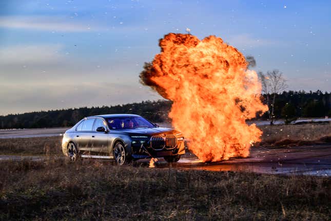 Front 3/4 view of an armored BMW 7 Series avoiding an explosion