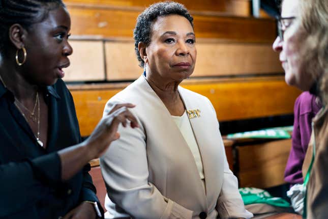 OAKLAND, CALIFORNIA - FEBRUARY 25, 2023: Chief of Staff Joyce Kazadi, left, and campaign staffer Katie Merrill, right, prepare backstage with Congresswoman Barbara Lee. 