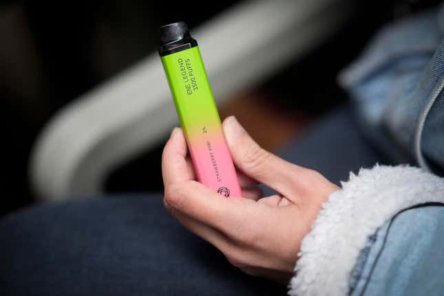 A woman holds a vaping device on May 30, 2023 in Manchester, England.