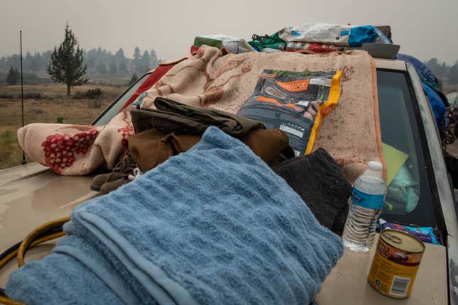  Towels, pet food and personal belongings are piled on the top of a car at an evacuation center on August 7, 2021 in Susanville, California. 