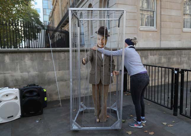 A protester arranges a figure resembling pro-Brexit politician Nigel Farage (former leader of the UK Independence Party) before the anti-Brexit demonstration in central London.