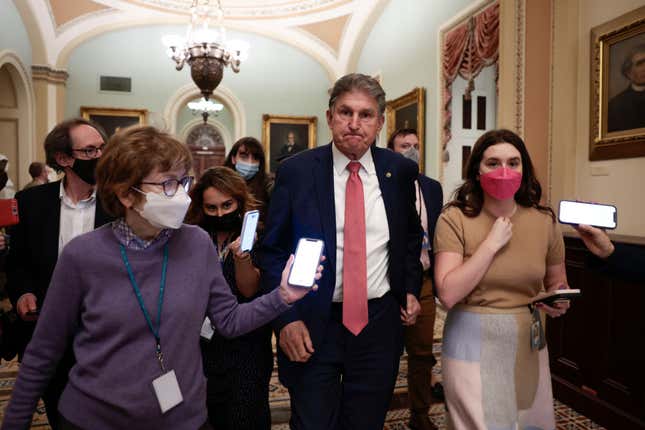 WASHINGTON, DC - DECEMBER 17: Sen. Joe Manchin (D-WV) is followed by reporters as he leaves a caucus meeting with Senate Democrats at the U.S. Capitol Building on December 17, 2021, in Washington, DC. Democrats continue to work on a path forward regarding the Build Back Better and election reform legislation ahead of the Holiday recess.