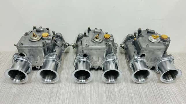 three weber carburetors on a table