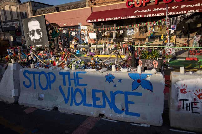 FILE- Barriers placed by the city of Minneapolis surround memorials as community members gather in George Floyd Square, June 7, 2021. Several stores where George Floyd was killed by Minneapolis police in 2020 are suing the city for about $1.5 million. The lawsuit by Cup Foods and several other businesses accuses the city of not policing the area and blocking customers from the businesses. (AP Photo/Christian Monterrosa)