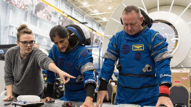 Boeing Crew Flight Test (CFT) crew members Butch Wilmore and Suni Williams during Suited Post-Landing Emergency Egress in the Boeing Starliner Mockup at NASA’s Johnson Space Center.