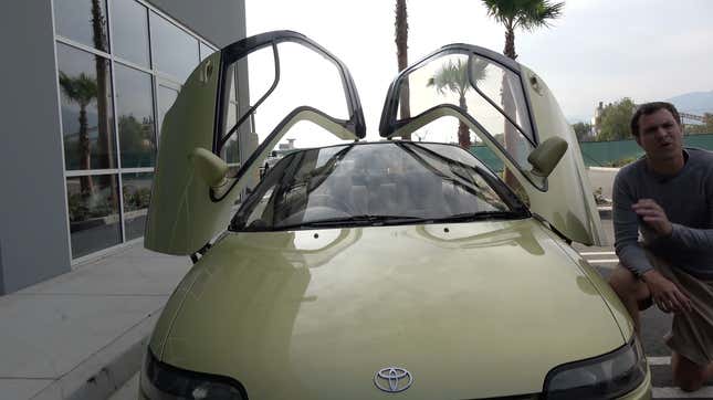 A frontal photo of the Sera with both doors open showing the glass roof and the driver's side door that opens wider than the passenger side.