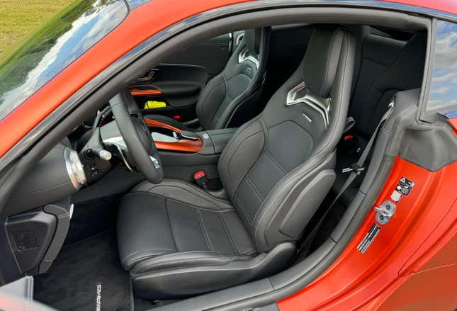 Front seats of a matte orange 2025 Mercedes-AMG GT63 S E Performance