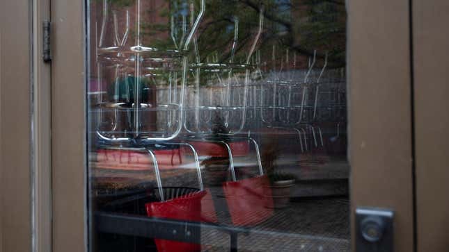 Chairs sit on tables of a closed restaurant in Ohio.