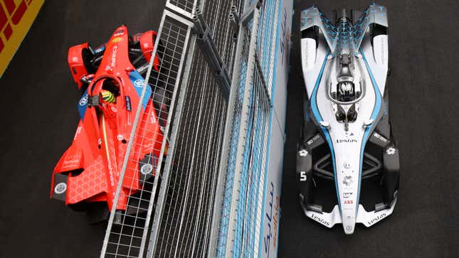 A photo of a Mercedes and Mahindra Formula E car at a race. 