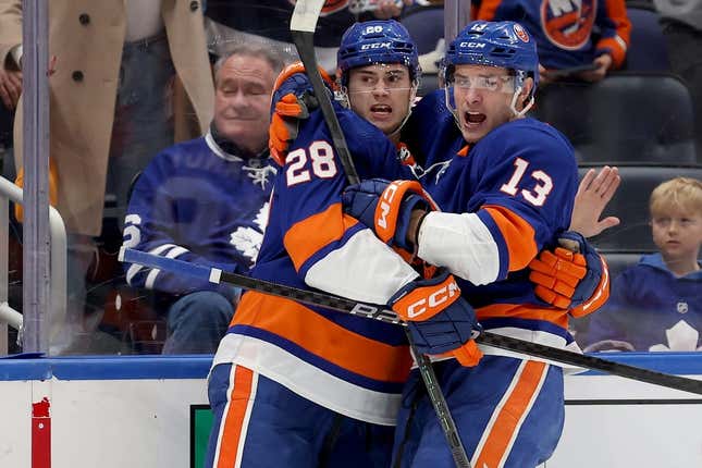 Jan 11, 2024; Elmont, New York, USA; New York Islanders defenseman Alexander Romanov (28) celebrates his goal against the Toronto Maple Leafs with center Mathew Barzal (13) during the second period at UBS Arena.