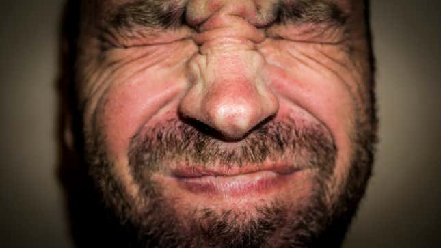 Man wincing