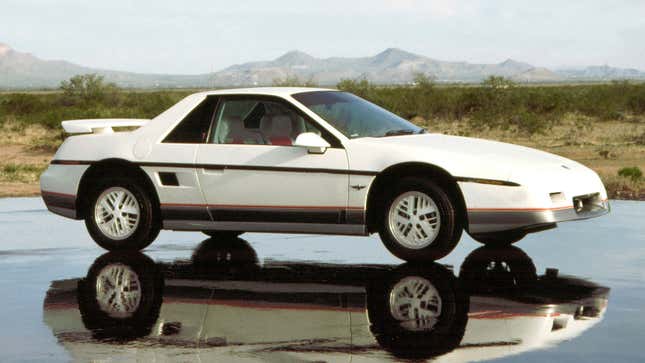 A photo of a white Pontiac Fiero sports car. 