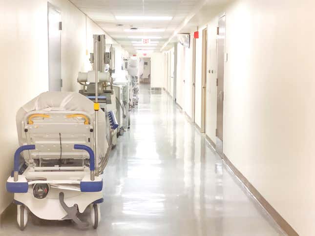 Hospital hallway corridor lined with medical equipment. 