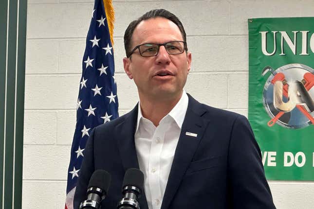 Pennsylvania Gov. Josh Shapiro speaks at a news conference at the United Association Local 524 union building in Scranton, Pa., on Wednesday, March 13, 2024. Shapiro announced he would back legislation to make power plant owners in Pennsylvania pay for their planet-warming greenhouse gas emissions and require utilities in the nation&#39;s third-biggest power-producer to buy more electricity from renewable sources. (AP Photo/Michael Rubinkam)