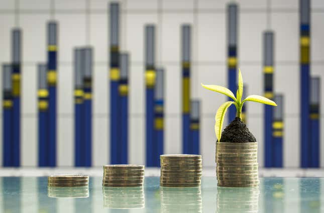 Stacks of coins get progressively larger until the tallest one sprouts a plant