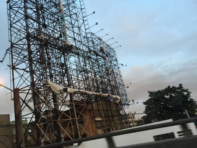Image for article titled Photos: Dismantled billboards, ghostly scaffolds as a city braces for a typhoon