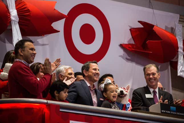 Target CEO Brian Cornell (C) rings the opening bell at the NYSE.