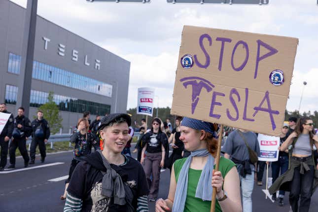 : Environmental activists protest near the Tesla Gigafactory electric car factory on May 11, 2024 close to Gruenheide, Germany.