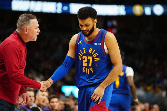 Nov 4, 2023; Denver, Colorado, USA; Denver Nuggets head coach Michael Malone checks on guard Jamal Murray (27) in the second quarter against the Chicago Bulls at Ball Arena.