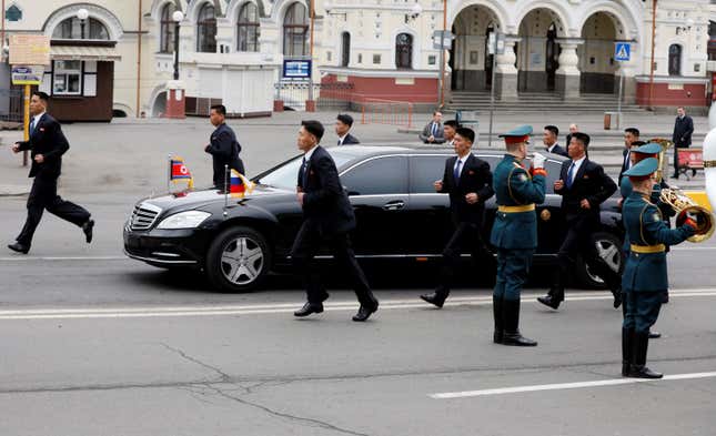 Kim Jong Un is escorted in a car surrounded by his bodyguards in Vladivostok, Russia, April 24, 2019.