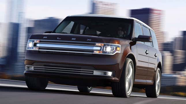 A photo of a purple Ford Flex SUV driving on a highway. 