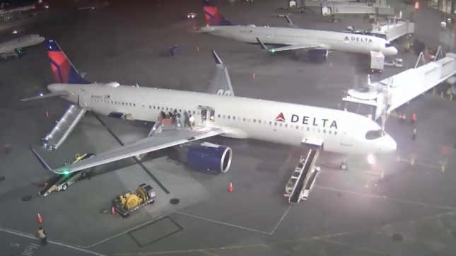 A screenshot of CCTV footage showing a fire breaking out on a plane. 