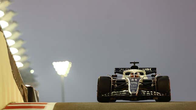 A photo of Nyck de Vries driving an Alpha Tauri F1 car in Abu Dhabi.