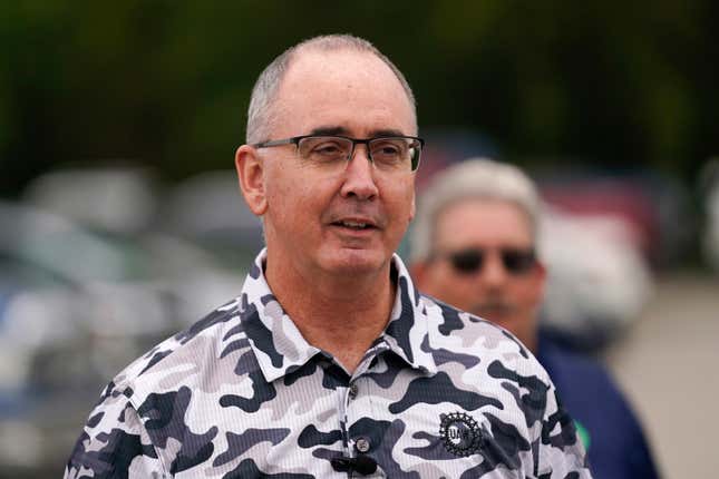 File - United Auto Workers President Shawn Fain talks with members picketing near a General Motors Assembly Plant in Delta Township, Mich., Friday, Sept. 29, 2023. Fain will update members on bargaining with Detroit&#39;s three automakers on Friday afternoon, (AP Photo/Paul Sancya, File)