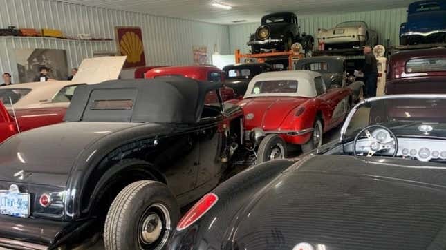 A photo of a warehouse full of classic cars. 